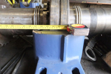 Tape measure measuring a part for cutting at Commercial Machine Service